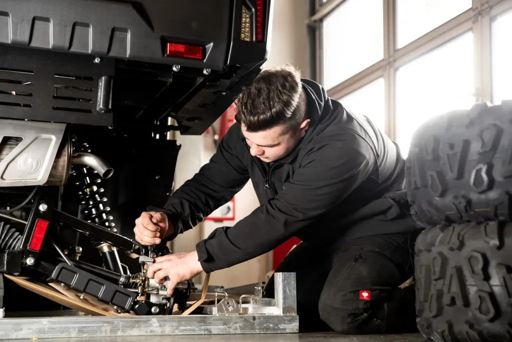 Mechaniker bei der Arbeit an einem Quad in der Bader Powersports Werkstatt in Neumarkt